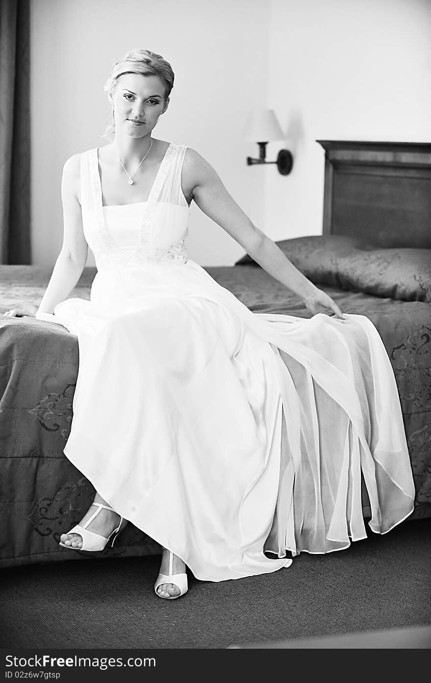 Beautiful stylish bride in white dress in room. Beautiful stylish bride in white dress in room