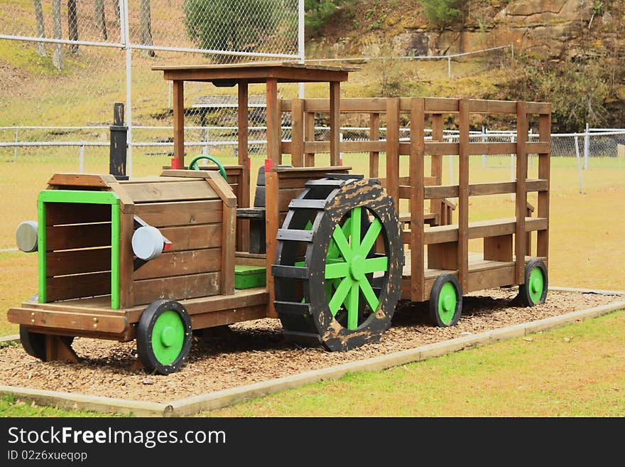 Wooden tractor in a playground. Wooden tractor in a playground