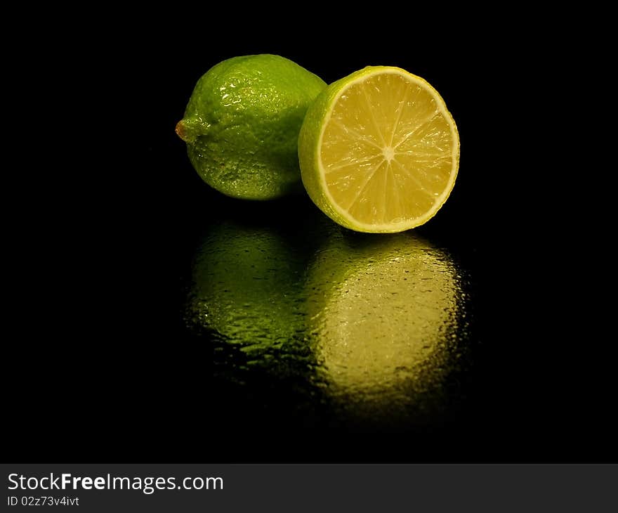 Citrus fruits on the white black with water drop