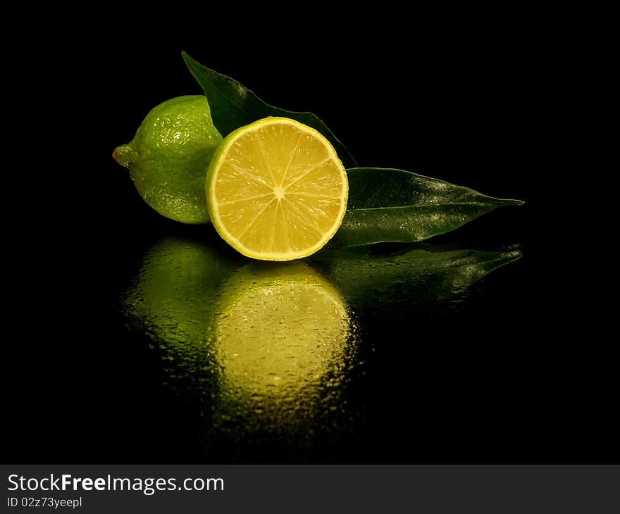 Citrus fruits on the white black with water drop