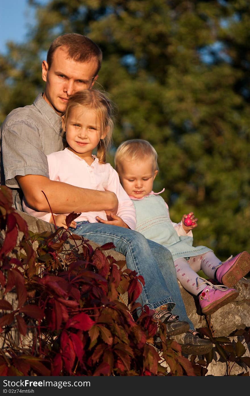 Father With Two Daughters In Summer