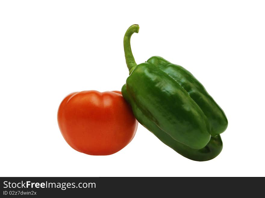 Ripe red tomato and green sweet pepper on a white background. Ripe red tomato and green sweet pepper on a white background