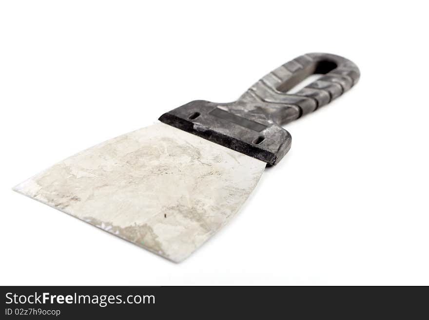 Isolated old and dirty palette knife for plaster walls