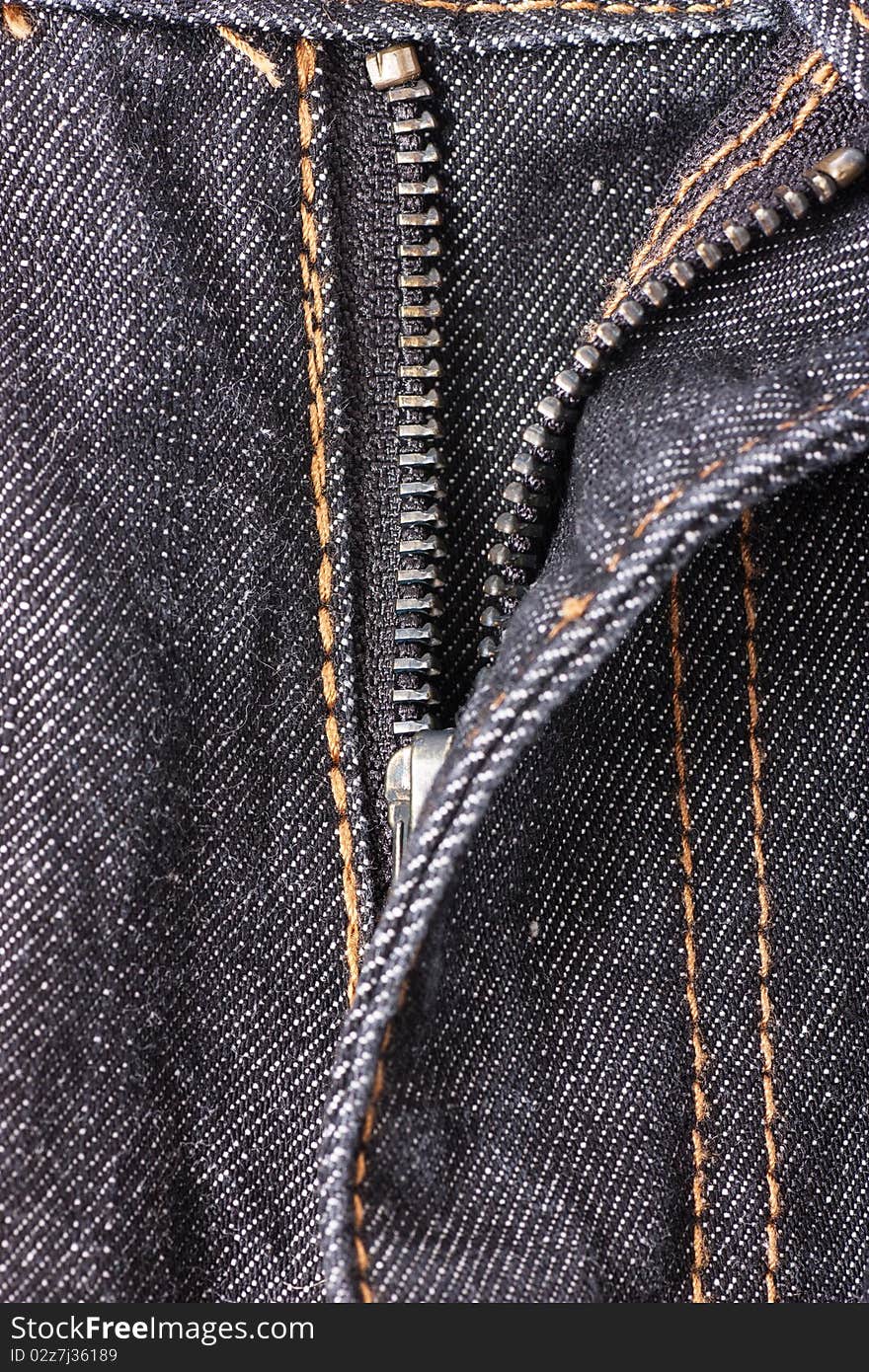 Closeup view of opened zipper on jeans.