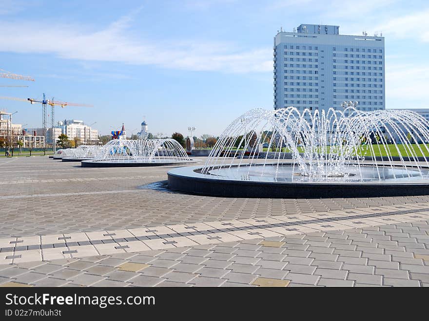 Row of fountains on sidewalk