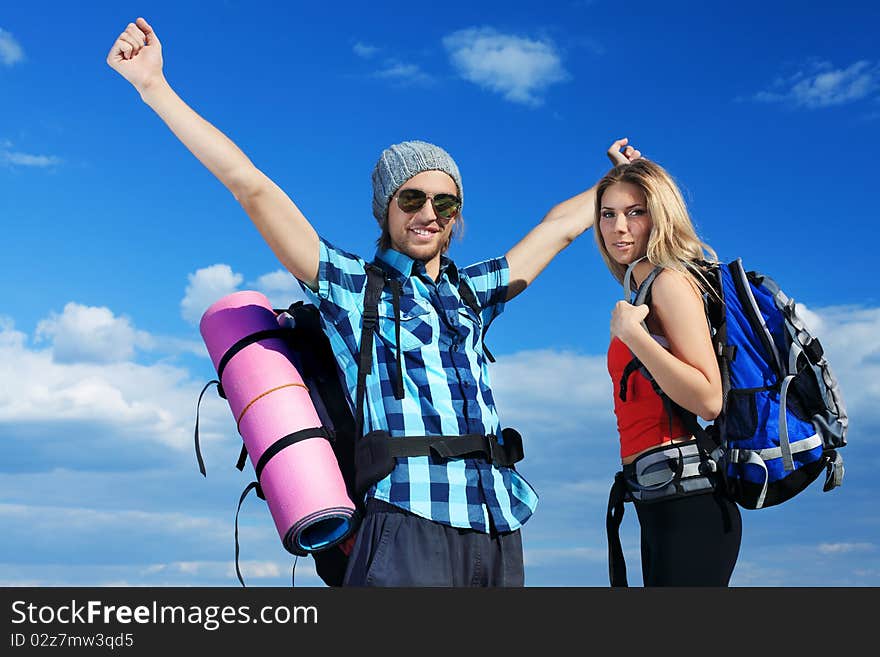 Couple of tourists are standing at the top of a mountain with a feeling of freedom. Couple of tourists are standing at the top of a mountain with a feeling of freedom.