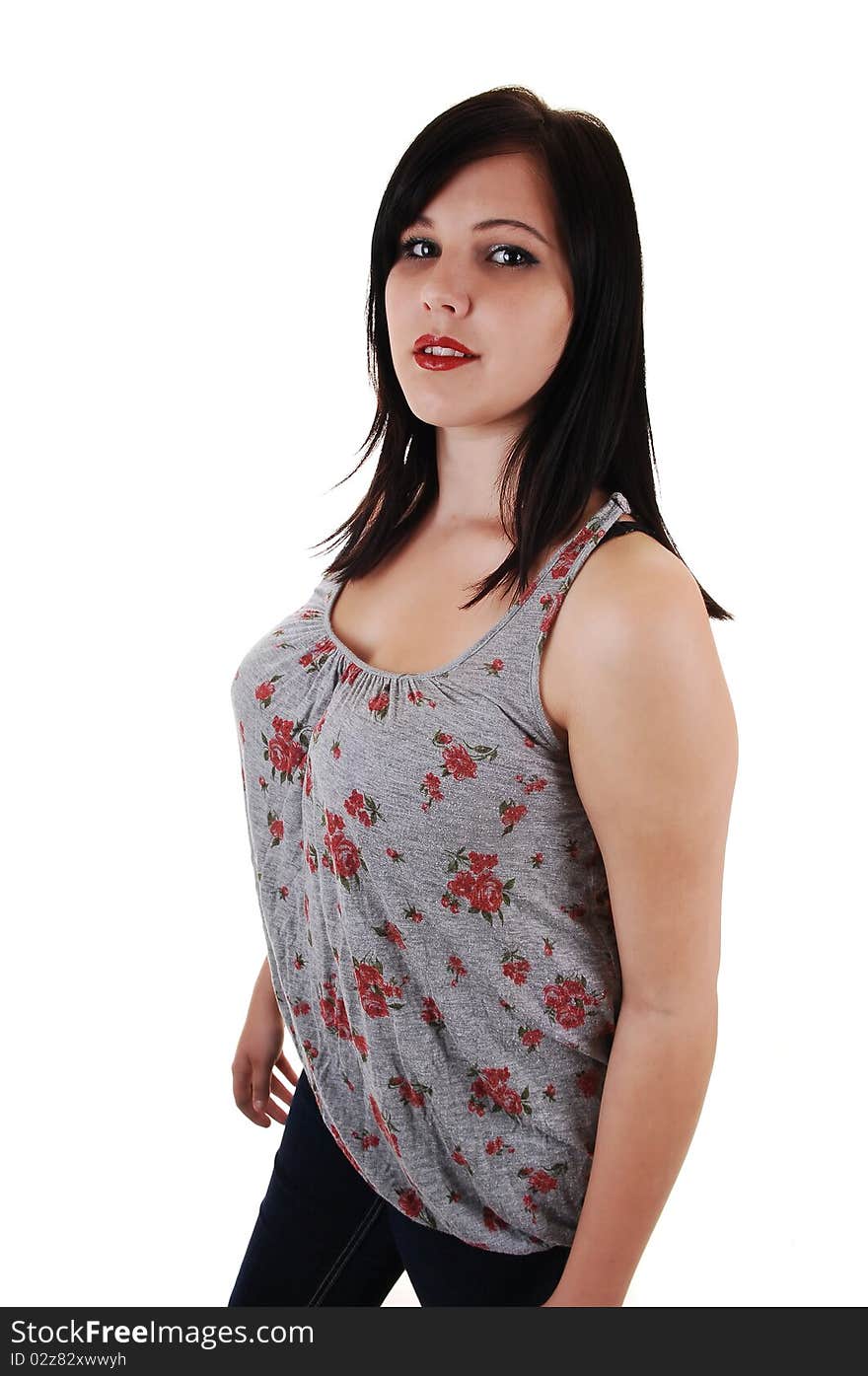 A young and pretty woman in a gray top and jeans, standing for a 
portrait in the studio, for white background. A young and pretty woman in a gray top and jeans, standing for a 
portrait in the studio, for white background.