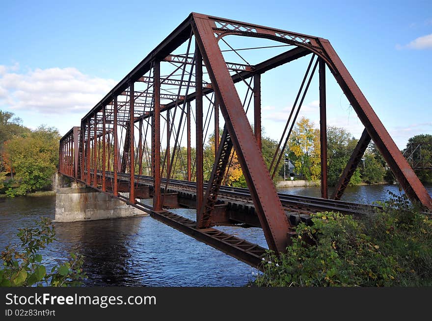 Rail length across the river on rusty steel bridge