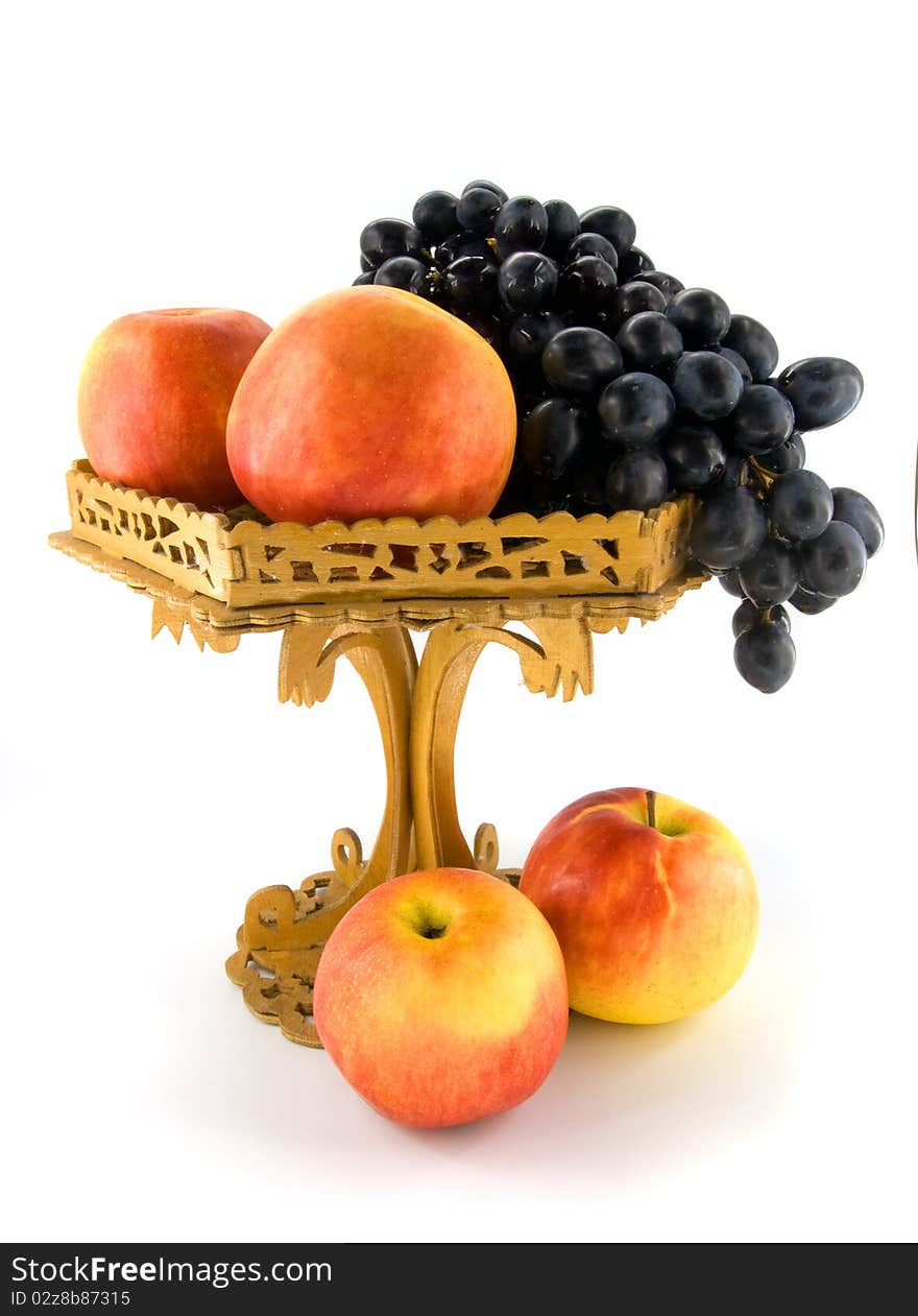 Fruits in woodem vase on white background