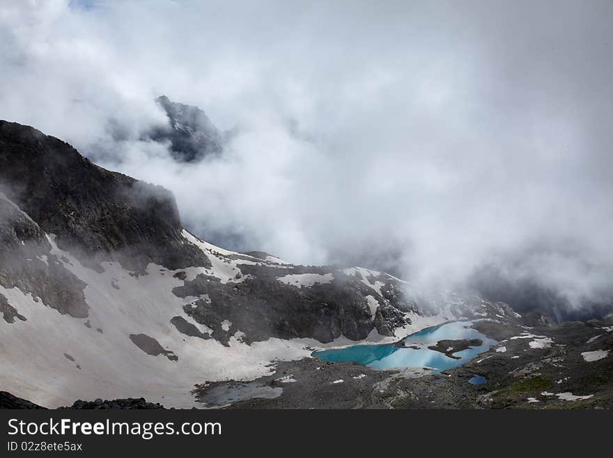 Mountain landscape with fog and lake