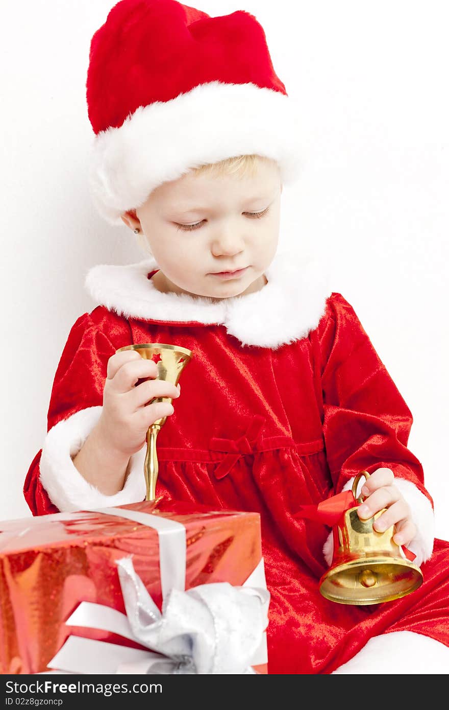 Little girl as Santa Claus with bells and Christmas present