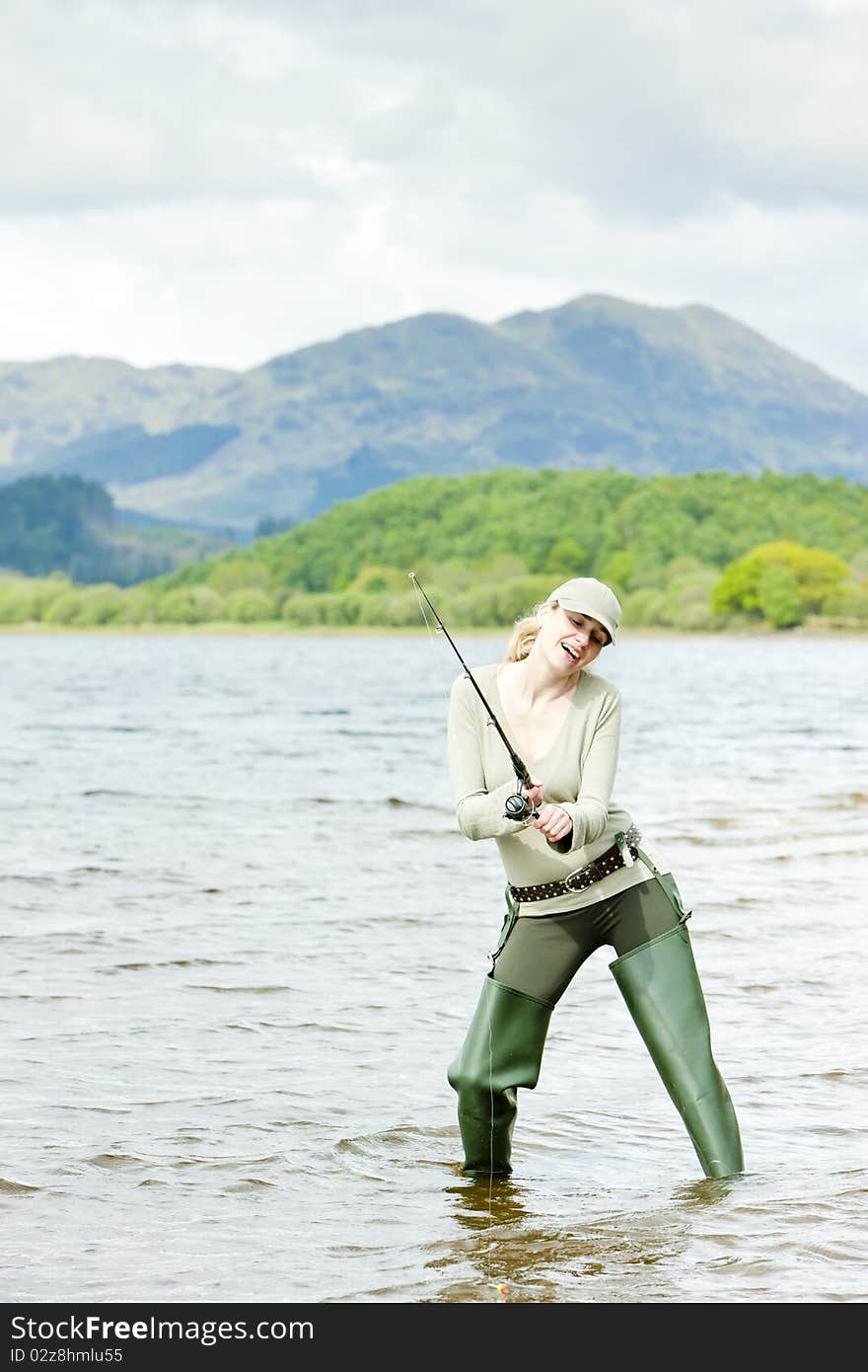 Fishing woman in Loch Venachar, Trossachs, Scotland. Fishing woman in Loch Venachar, Trossachs, Scotland