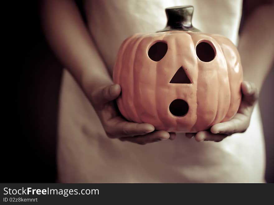 Child holds the pumpkin