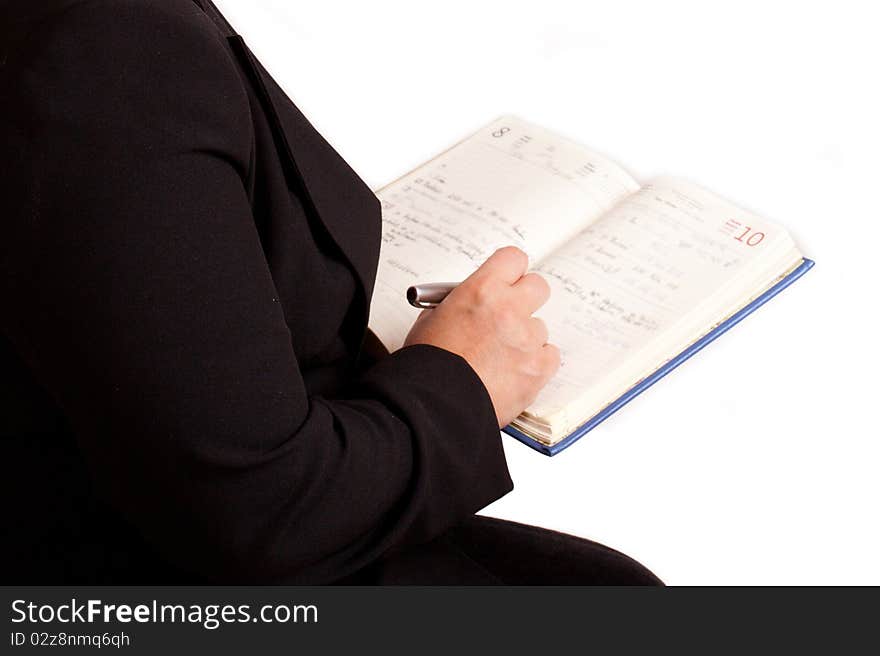 Businessman writing a note to a notebook. Businessman writing a note to a notebook