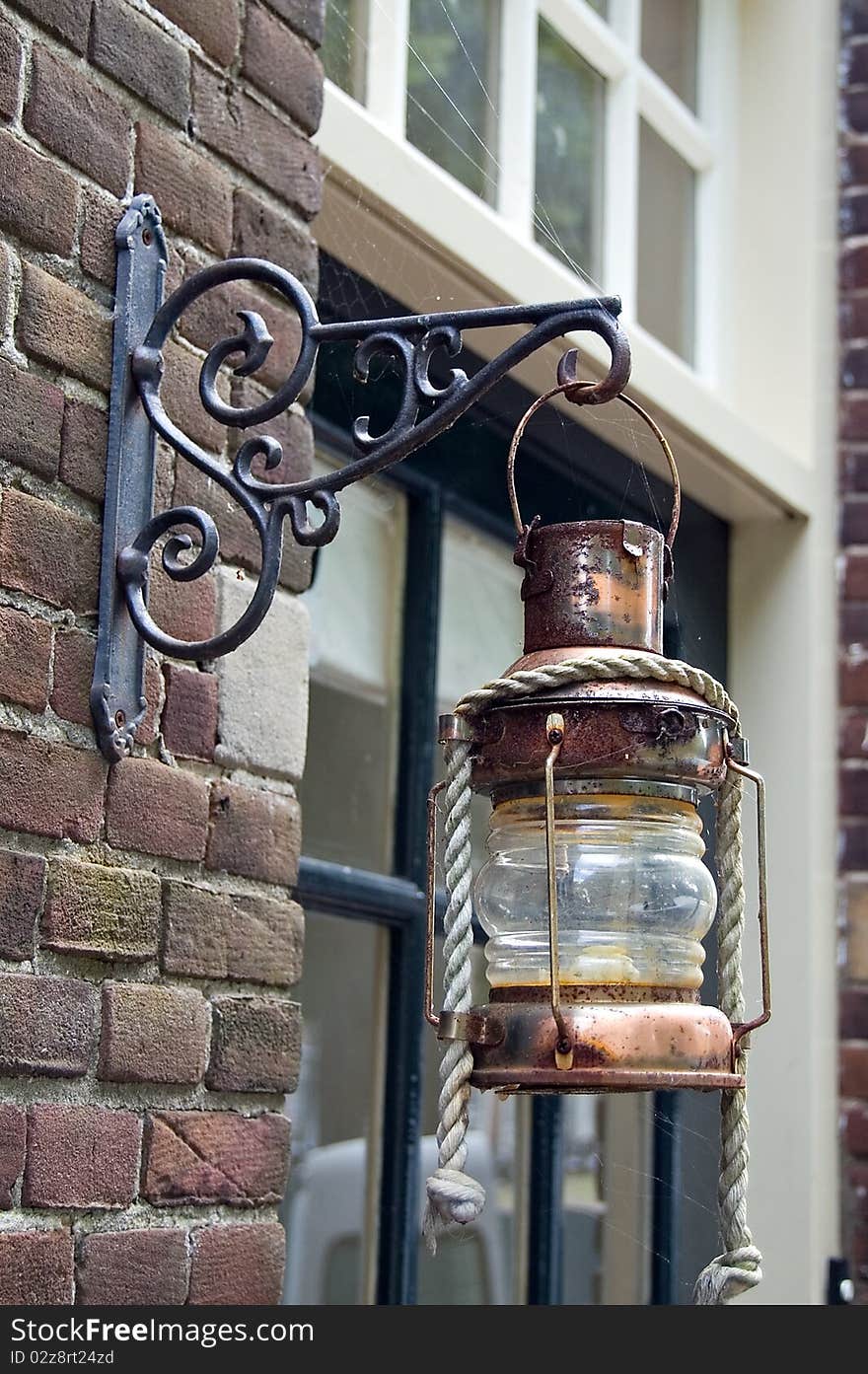 A brass lantern hanging outside a house in Edam. A brass lantern hanging outside a house in Edam.