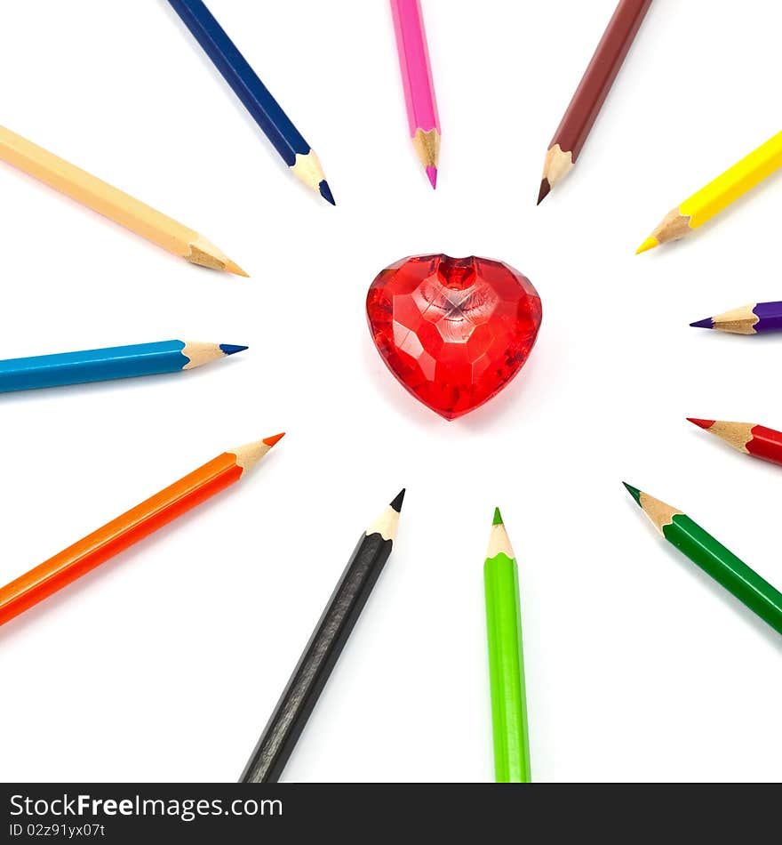 Red crystal heart surrounded with color pencil. Red crystal heart surrounded with color pencil