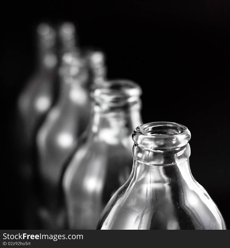 Empty bottles collection, colorless, isolated on black background