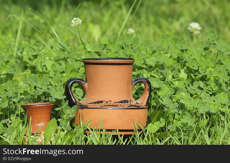 Brown vases with a grass background