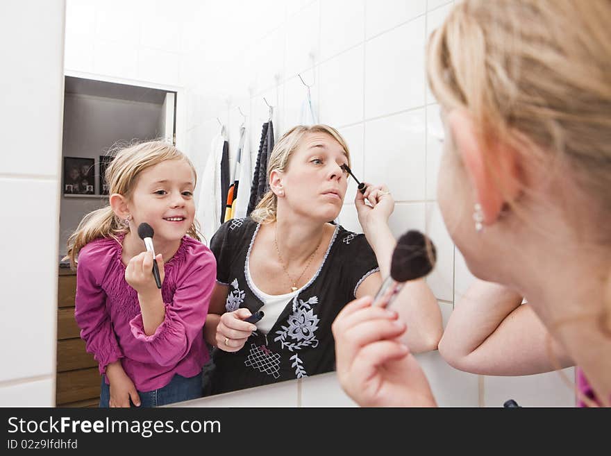 Mother And Daughter Put On Make-up