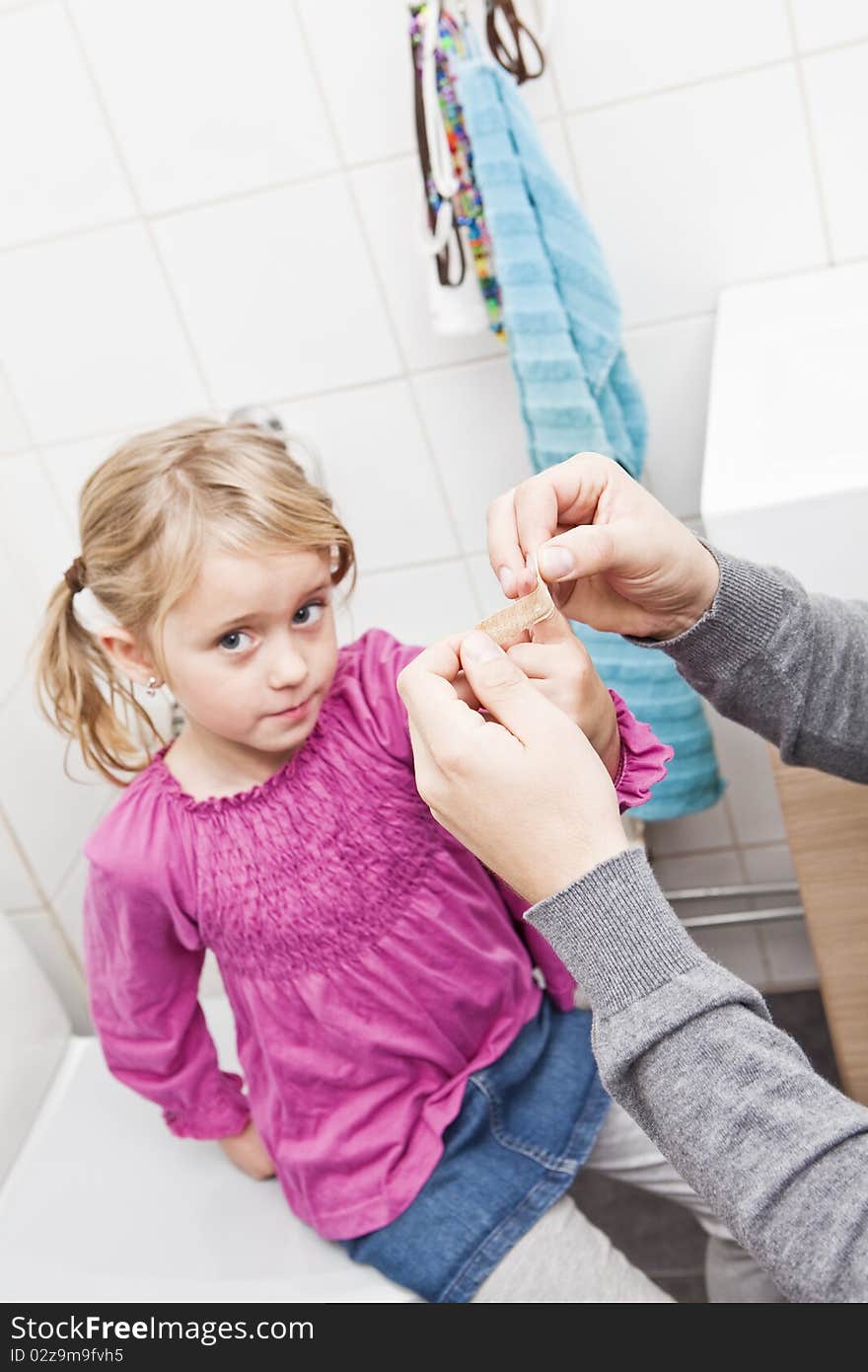 Father and Daughter Band-Aid in the Bathroom