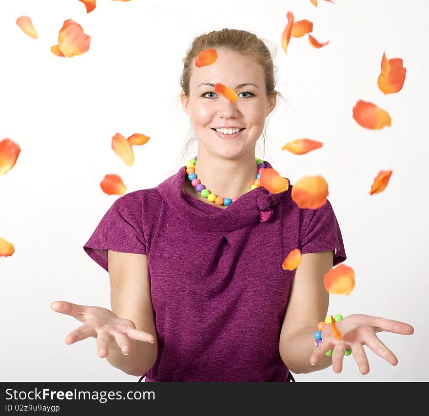 Smiling girl among flying petals