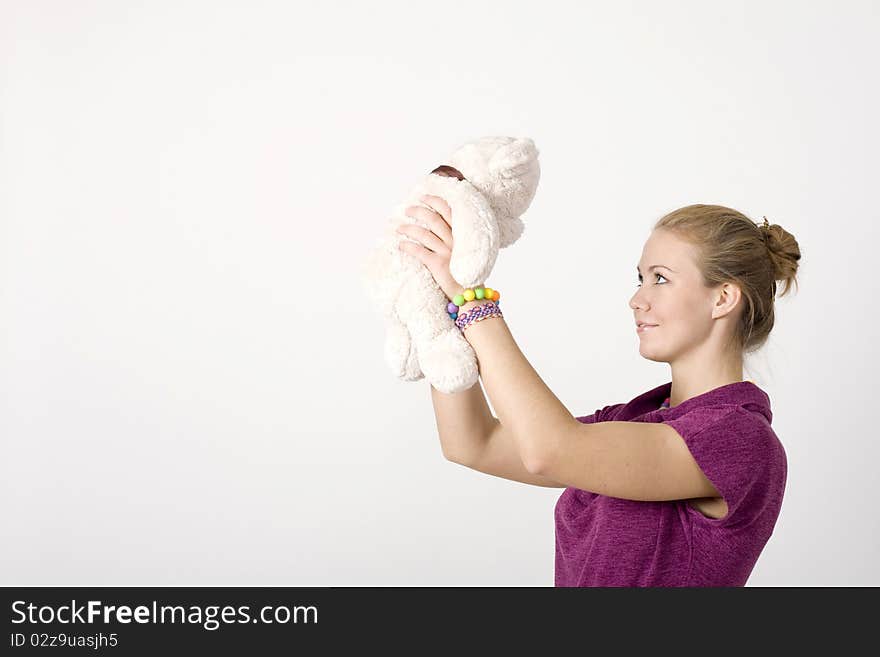 Smiling girl with a toy bear