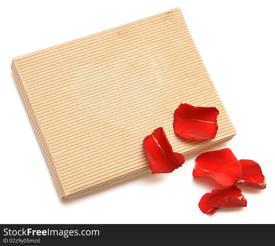 Red rose petals and gift on white background