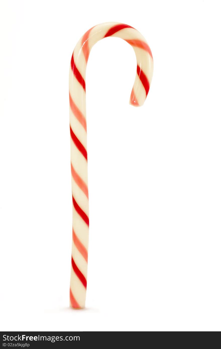 Red and pink striped candy cane isolated over white. Red and pink striped candy cane isolated over white