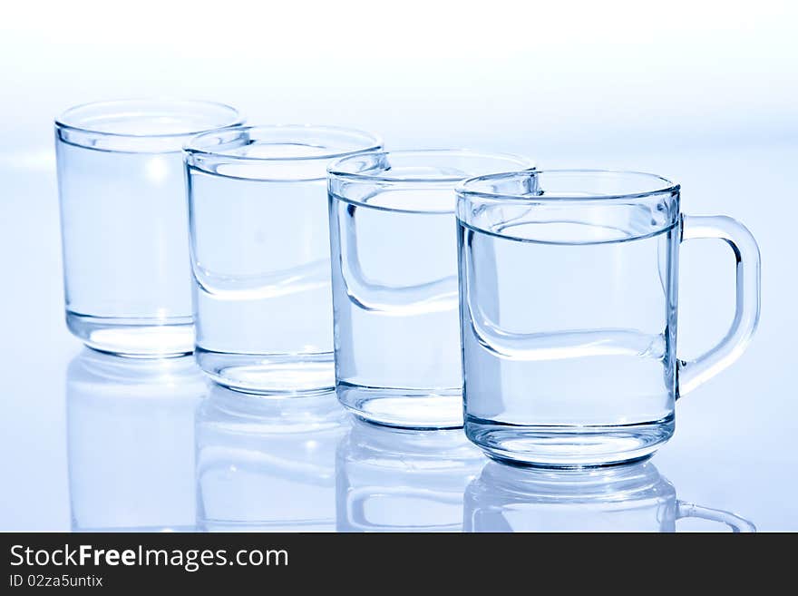 Four water-filled blue glass