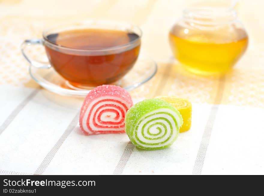 Colored jelly and mug with tea