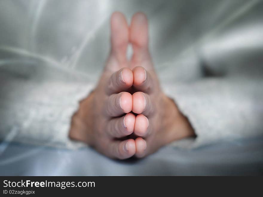 Young man's palms in calm position at abstract background