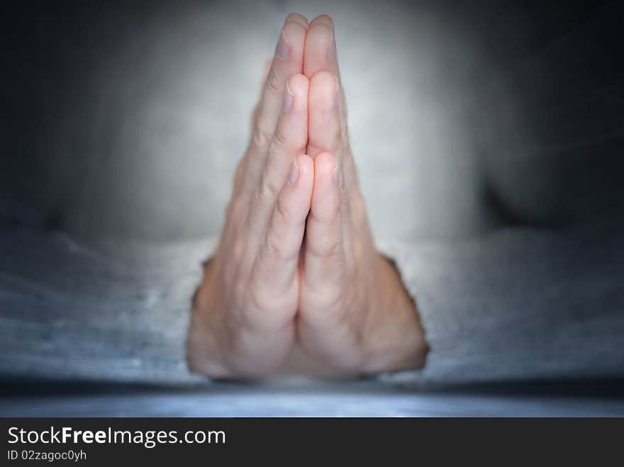 Young man's palms in calm position at abstract background