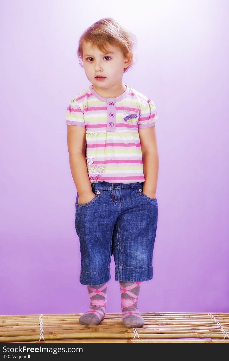 Girl on a violet background, hands in pocket