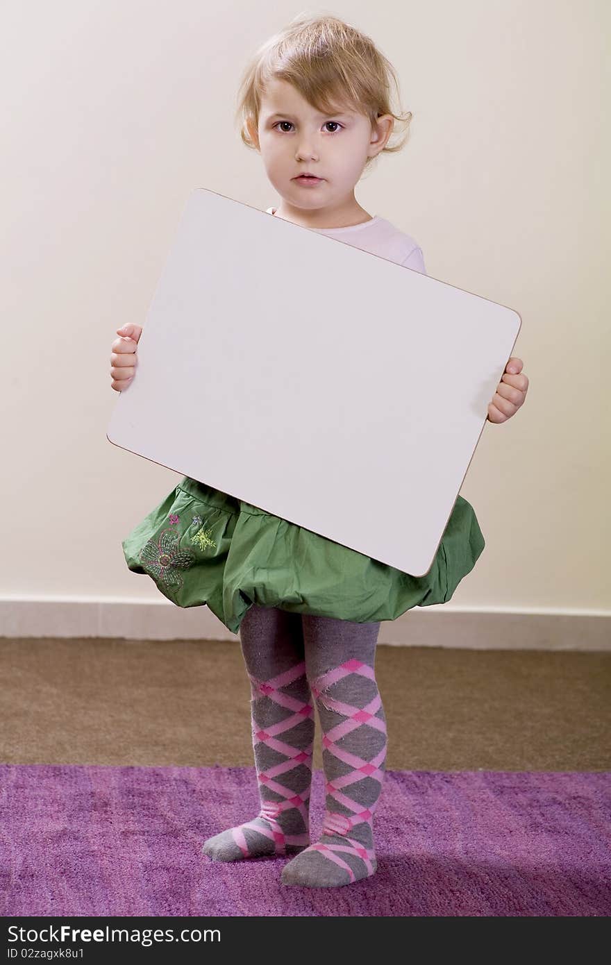 3-years old girl holding a white board