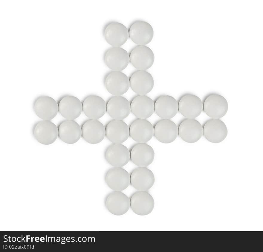 Cross-shaped group of pills isolated on white