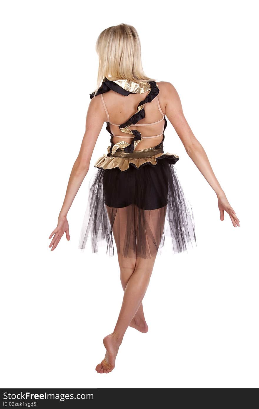 A dancer in a gold and black dance outfit showing her pose. A dancer in a gold and black dance outfit showing her pose.