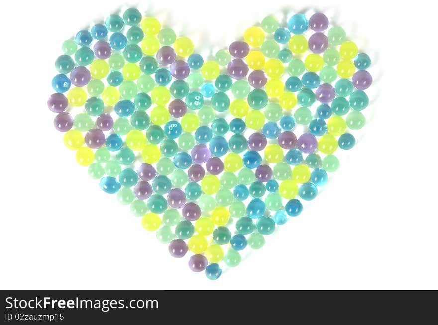 Water absorbent colorful balls , heart background. Water absorbent colorful balls , heart background