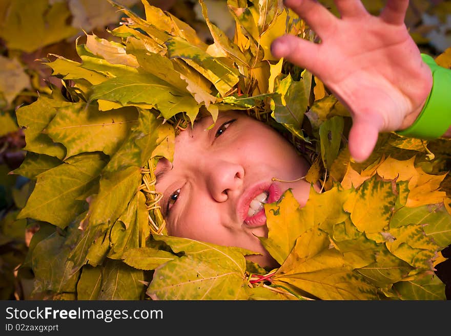 Woman Covered By Autumnal Leaves