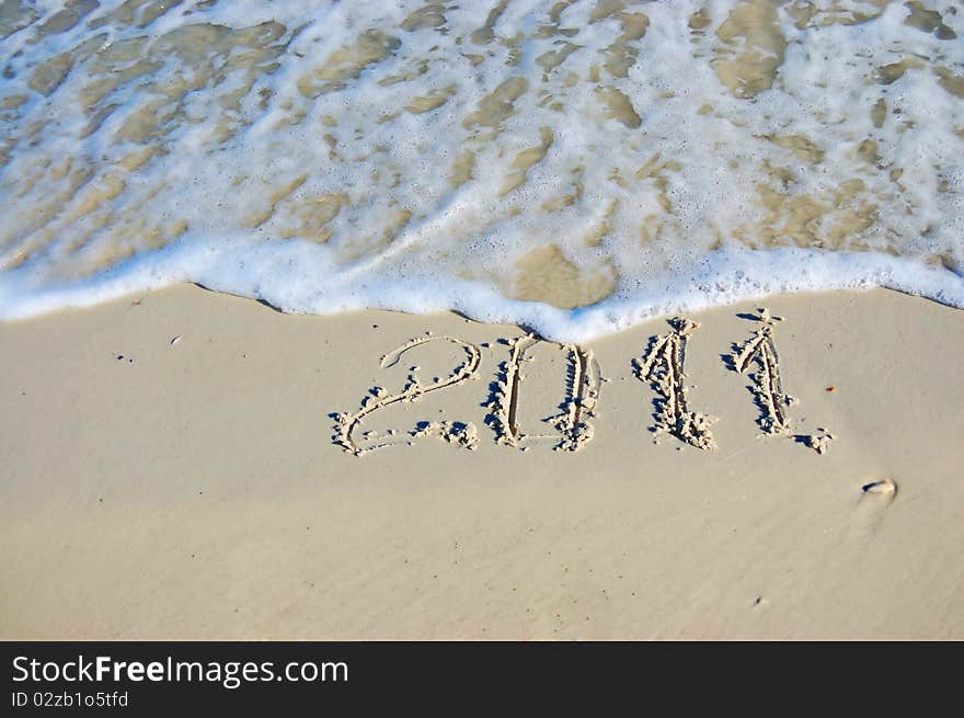 The inscription on the sand - 2011, the new year. Background. The inscription on the sand - 2011, the new year. Background