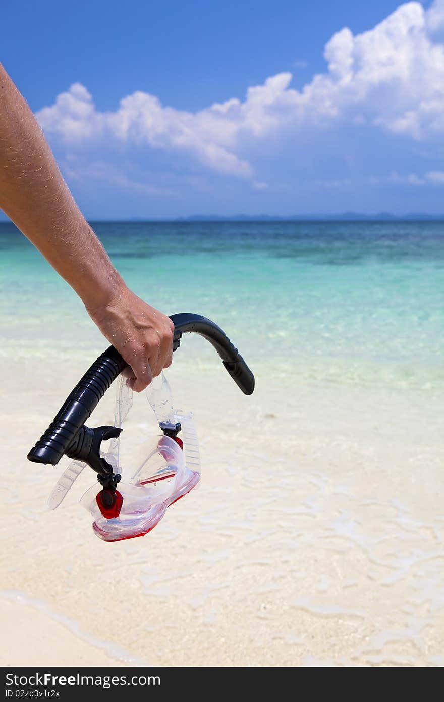 Woman carrying snorkeling equipment on the beach in paradise. Woman carrying snorkeling equipment on the beach in paradise.