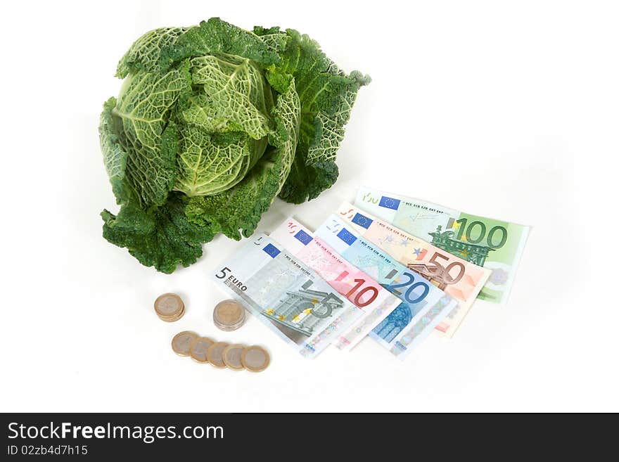 A head of savoy cabbage  with five banknotes on white background. A head of savoy cabbage  with five banknotes on white background