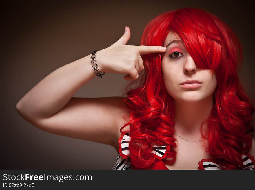 Attractive Red Haired Woman Wearing Bunny Ear Hat on a Grey Background.