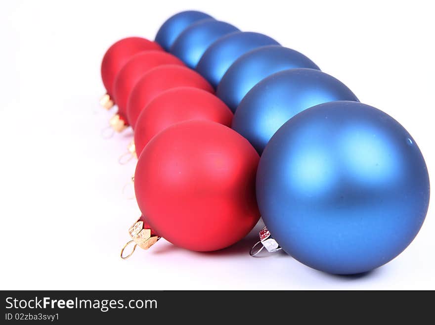 Blue and red matt christmas balls on white background, with space for your text. Blue and red matt christmas balls on white background, with space for your text