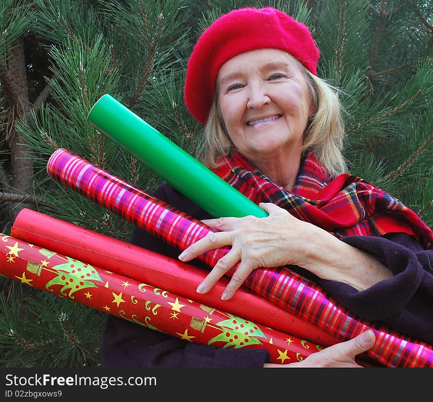 Woman getting her christmas tree and gift wrapping paper in time for christmas. Woman getting her christmas tree and gift wrapping paper in time for christmas.