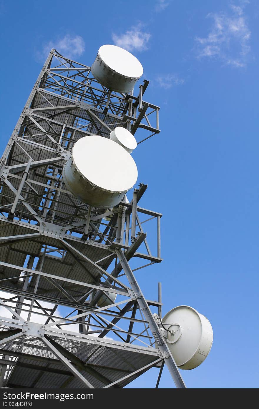 Communication tower on the blue sky background.