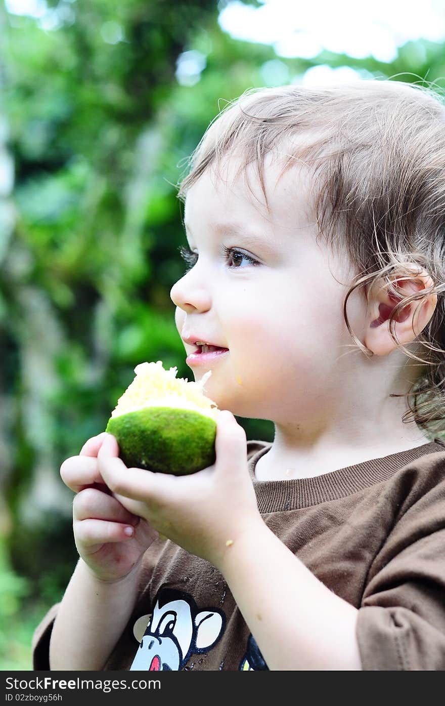 Little Girl Eating An Orange