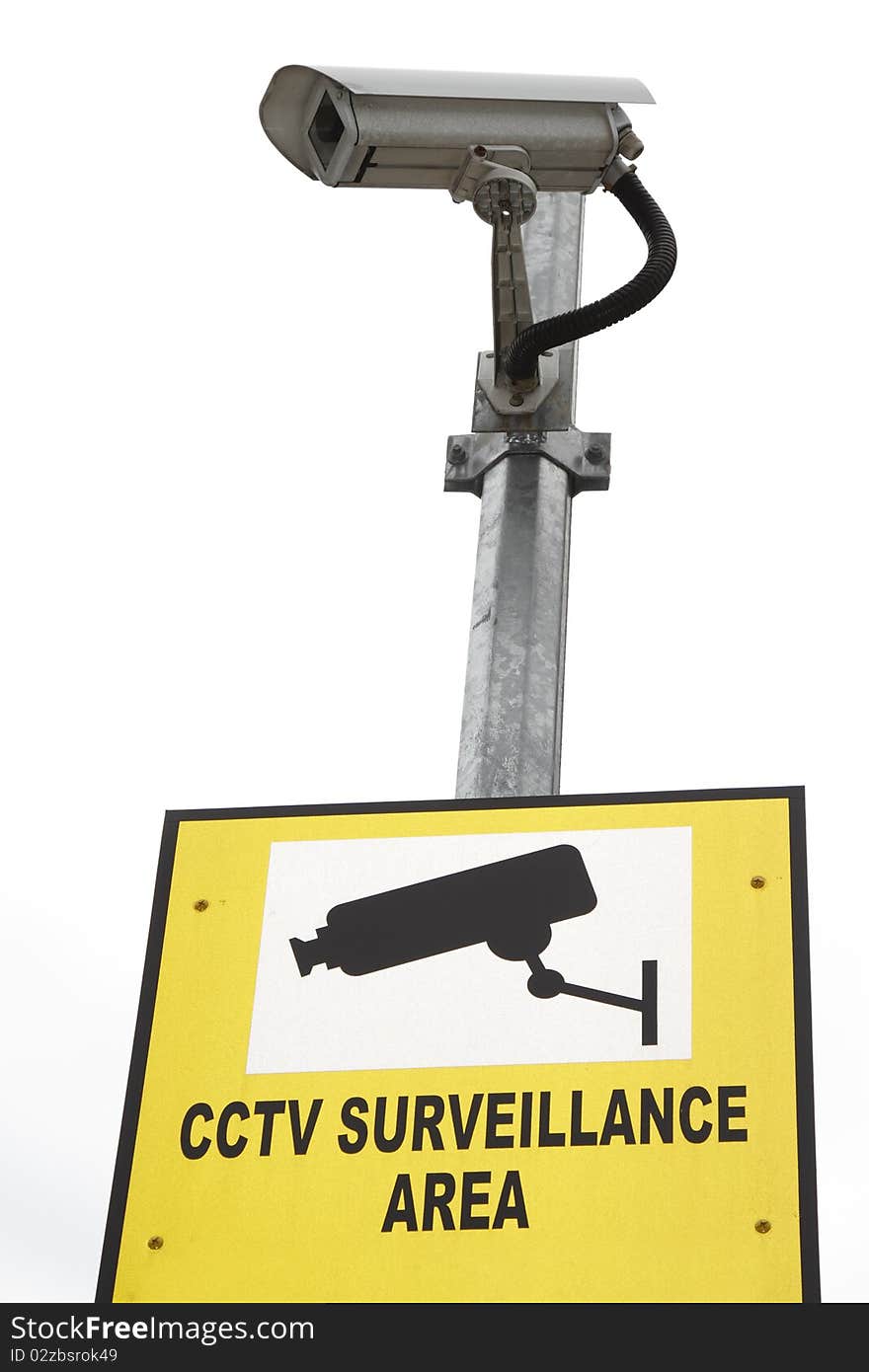 A security camera with a signboard stating CCTV Surveillance Area against a bright background