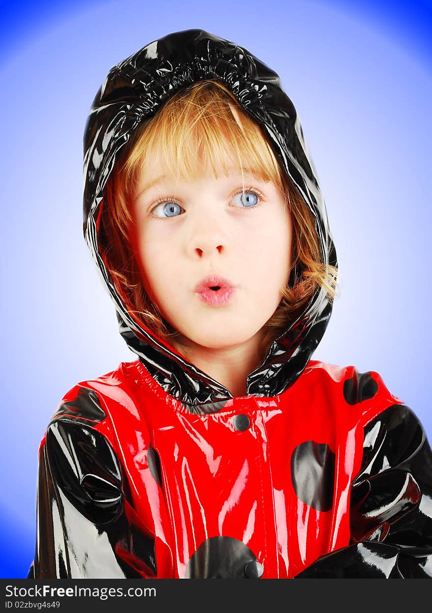 Studio shot with child portrait with red raincoat isolated on the gradient background. Studio shot with child portrait with red raincoat isolated on the gradient background.