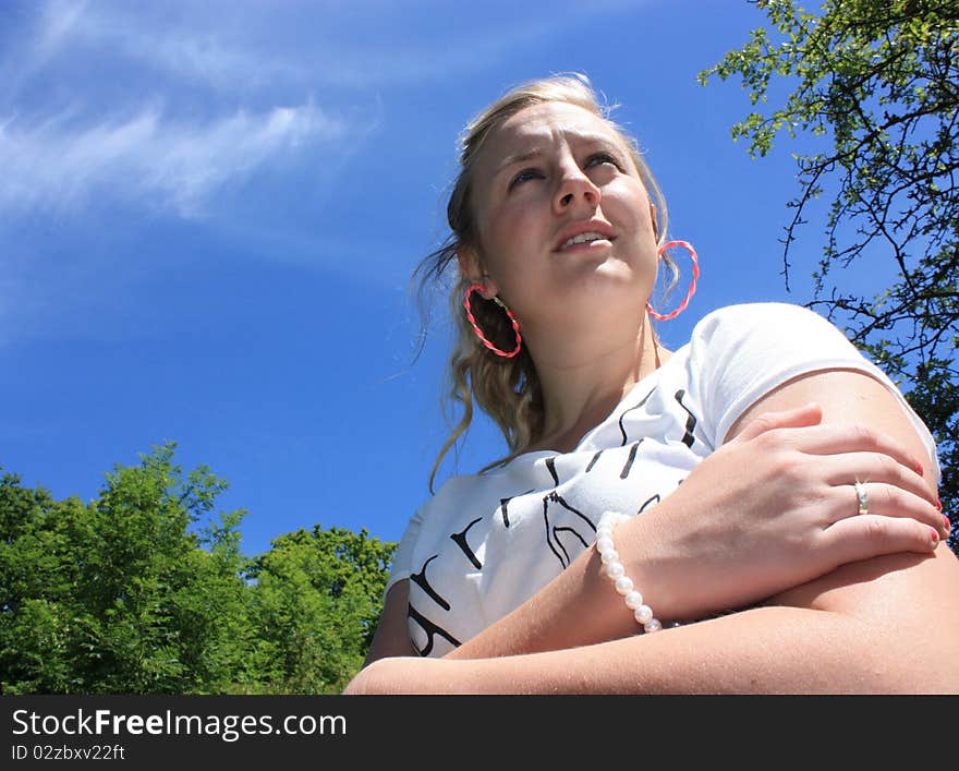 A beautiful young lady looks in to the distance on a gorgeous day. A beautiful young lady looks in to the distance on a gorgeous day