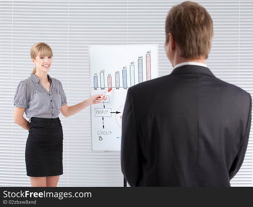 Businesswoman in a presentation pointing at a whiteboard. Businesswoman in a presentation pointing at a whiteboard